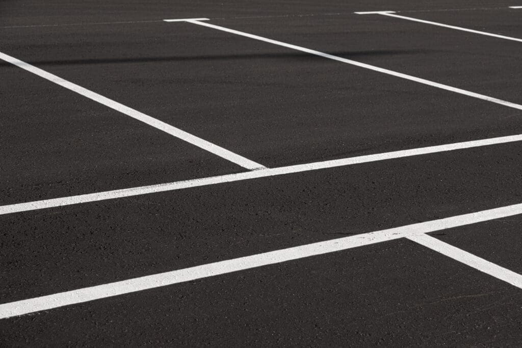 Close-up,Of,Freshly,Marked,Parking,Lot,With,White,Lines